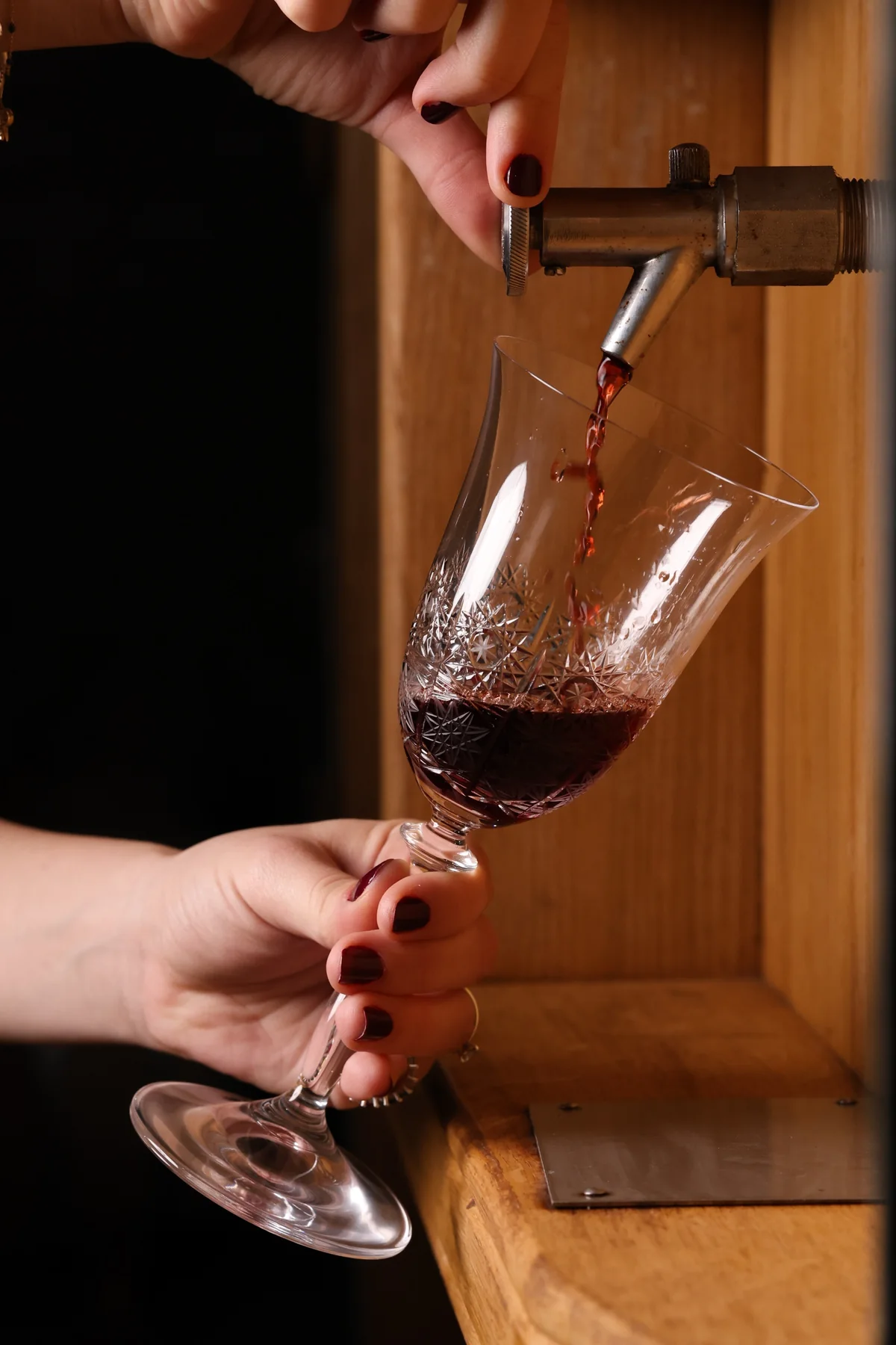 Wine poured from the cellar tap into a crystal glass